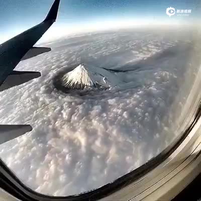 飞机上鸟瞰富士山 白云环抱流云流水