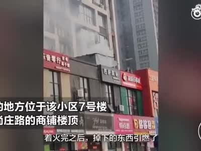 郑州一小区楼顶着火引燃违建 围观者站满一条街