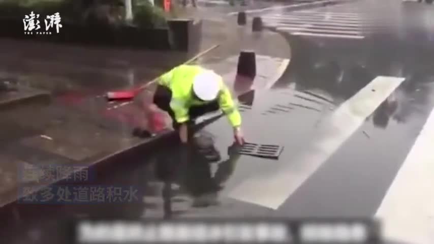 视频：防道路积水 交警雨中徒手疏通下水道