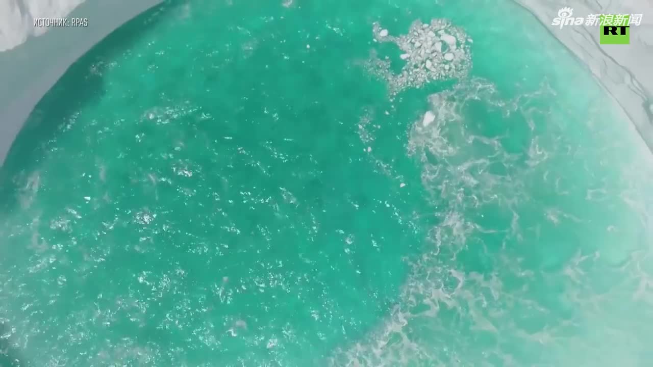 航拍：巨型冰山随波浪漂浮 造型奇特如天然游泳池