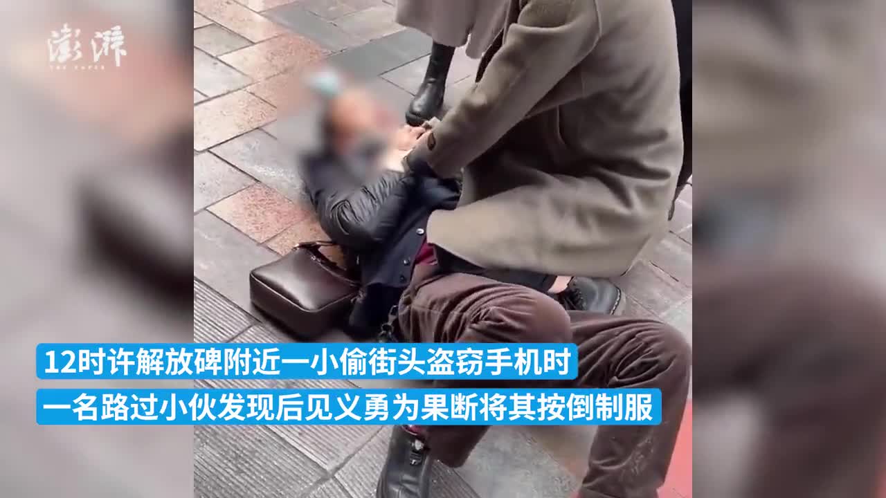 重庆街头扒手偷手机,小伙见义勇为将其按倒在地